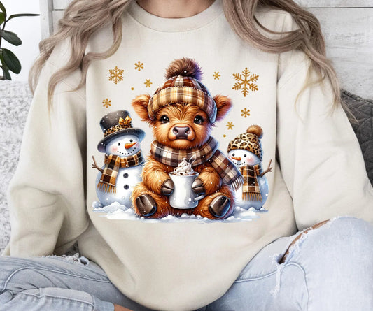 Highland cow with snowman